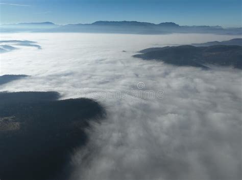 Aerial View Flying Over The High Mountains In Beautiful Clouds Aerial