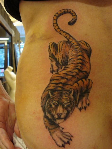 Phoenix is not commonly seen covering the back of women, but those who want to manifest their wish for transformation, rebirth, and power gladly tattoo phoenix which is a legendary, elegant and magnificent animal that is believed to live for hundreds of years around the world. Women Back Tiger Tattoo Design for 2011 - YusraBlog.com