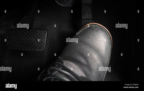 Foot Pressing Foot Pedal Of A Car To Drive Accelerator And Brake Pedal