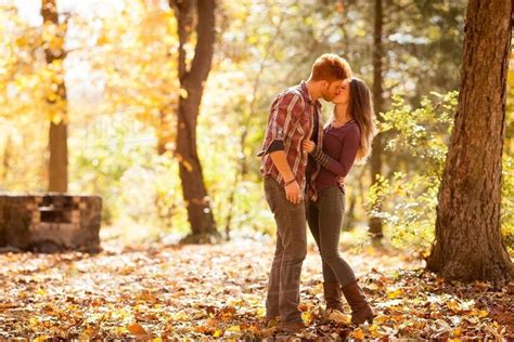 Young Couple Kissing In Autumn Forest Stock Photo Dissolve