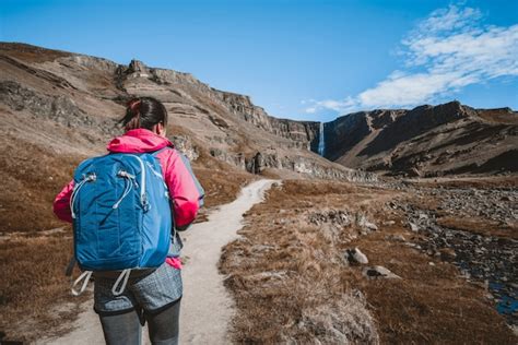 Premium Photo Traveler Hiking At Henoss Waterfall Iceland