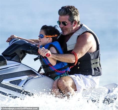 simon cowell s girlfriend lauren silverman sizzles in a swimsuit as their son eric goes jet