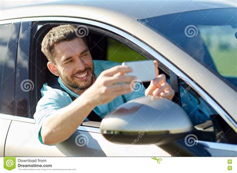 Happy Smiling Man With Smartphone Driving In Car Stock Photo Image Of