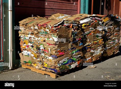Stacks Of Compressed Cardboard Packing Boxes On Wooden Pallets Or Stock