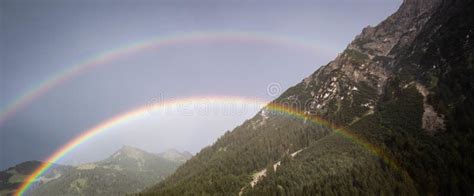 Beautiful View Of A Double Rainbow Over The Mountains And Forests Stock