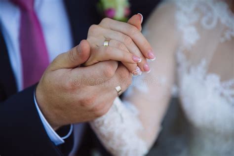 Closeup Groom And Bride Are Holding Hands At Wedding Day Ang Show Rings