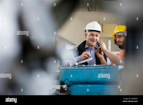 Male Supervisor With Worker Examining Metal In Industry Stock Photo Alamy