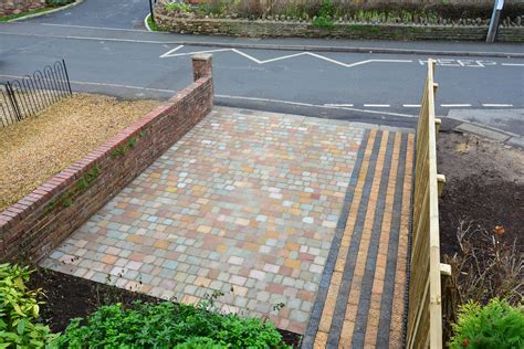 A Cobblestone Driveway And Pathway With New Fencing Cobblestone