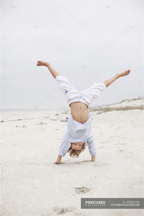 Cheerful Boy Doing Handstand On Sandy Beach — Freedom Cute Stock