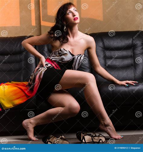 Woman Sitting On A Leather Sofa Stock Photography Image