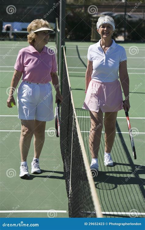 Senior Female Tennis Players Standing At Net Stock Image Image Of