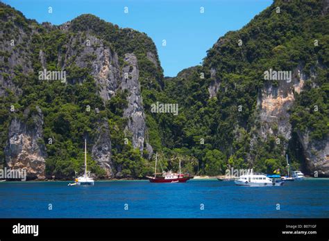 Tropical Island Cliffs With Trees Rise Above Waters Of Andaman Sea