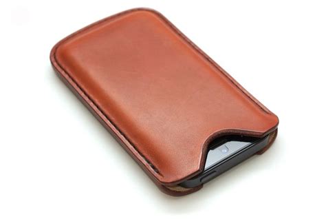 A Brown Leather Case For A Cell Phone On A White Background With Clippings