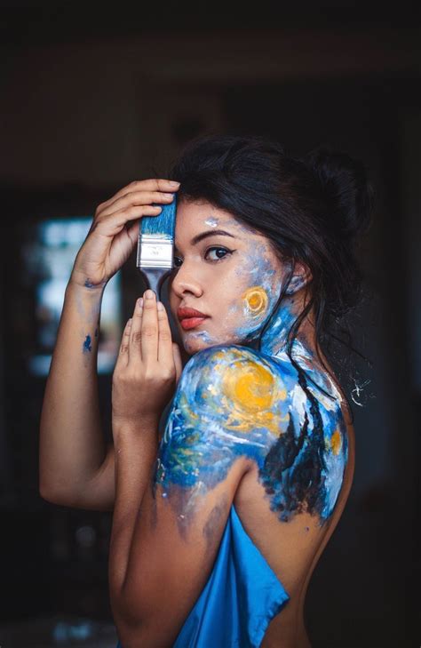 A Woman With Her Face Painted And Holding A Cell Phone