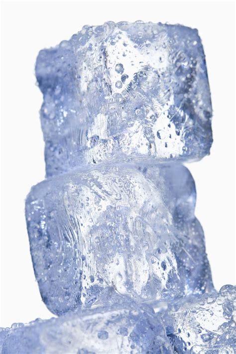 Stack Of Ice Cubes Against White Background Close Up Stock Photo