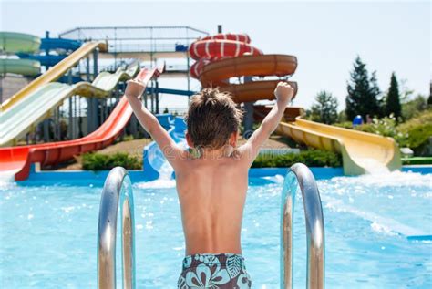 Healthy Happy Little Kid Near Blue Swimming Pool In Water Park With
