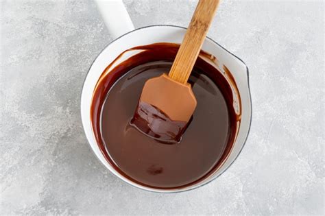 Premium Photo A White Bowl Of Melted Chocolate With A Spatula In It
