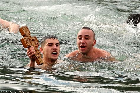 Orthodox Christians Plunge Into Icy Waters For Epiphany Celebration
