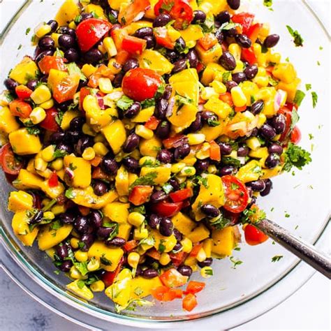 Combining mangoes, black beans, tomatoes, red onion, bell pepper, corn, and a simple salad. Mango Black Bean Salad - iFOODreal - Healthy Family Recipes