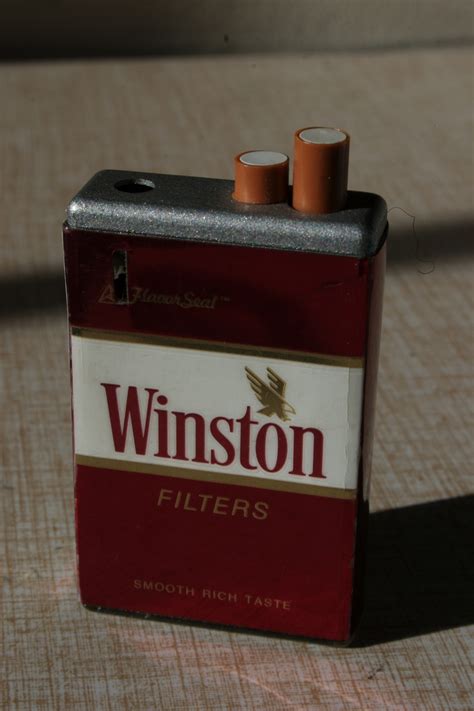 Remove a cigarette from the pack a place it comfortably between your lips in a relaxed manner. Four Cigarette Advertising Lighters... | Collectors Weekly