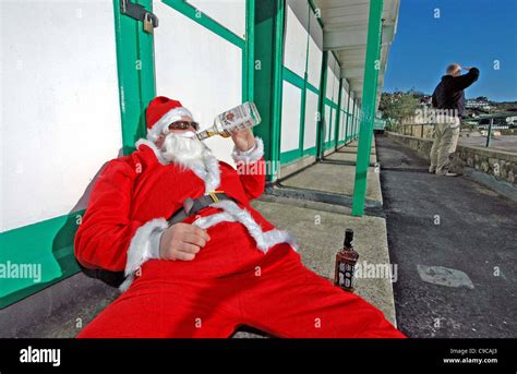 Drunk Santa Claus At Langland Bay Near Swansea While A Surfer Checks