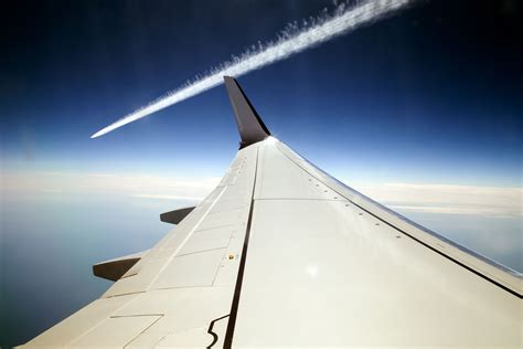 Dramatic Airplane Vapour Trail Passing A Plane Wing Seen From Inside