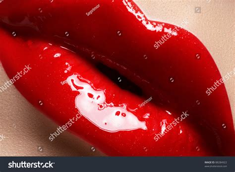 Close Up Of Womans Lips With Bright Fashion Red Glossy Makeup Macro