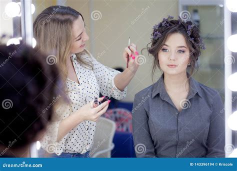 Stylist Makeup Artist Doing Makeup And Hair In A Beauty Salon
