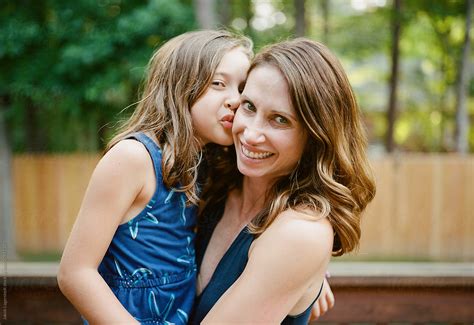 Daughter Kissing Mothers Cheek By Stocksy Contributor Jakob