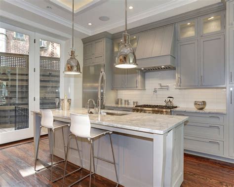 In this kitchen, light grey cabinets are complemented by a large black island countertop. Grey Cabinets White Countertops | Houzz