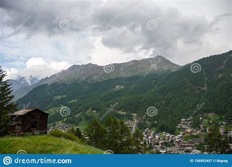 View In The Mountains With Old Wooden Barns On The Mountainside Meadow
