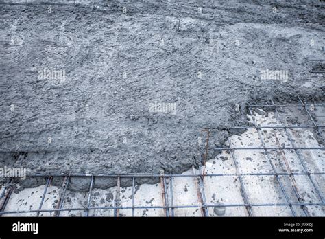 rebar grids with wet cement in concrete floor pouring process Stock