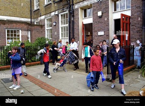 Parent Picking Up Children From Primary School Uk Stock Photo Alamy