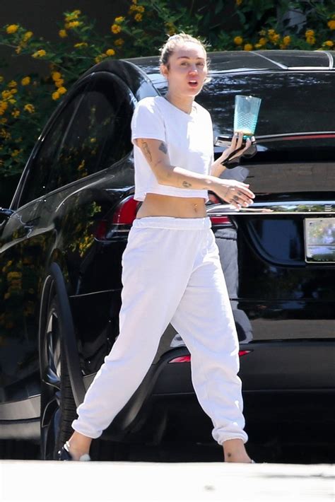 Miley Cyrus Flashes Her Abs In A White Crop Top And Sweat Pants While Visiting Friends In Malibu