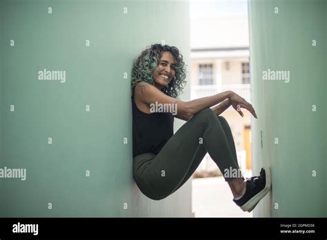 Happy Woman Leaning Against Wall Stock Photo Alamy
