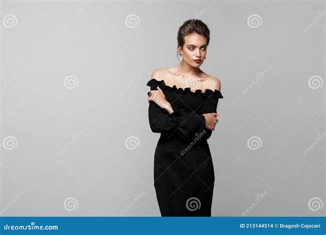 Elegant Model With Red Lipstick In Black Dress With Naked Shoulders