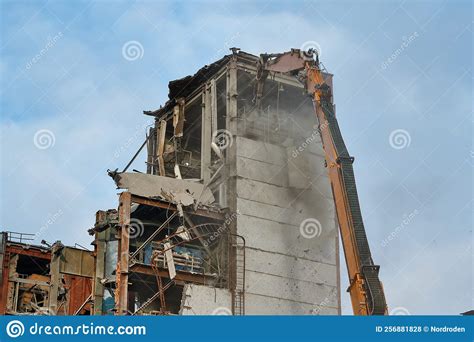 Hydraulic Scissors Destroy Abandoned Industrial Building Stock Photo