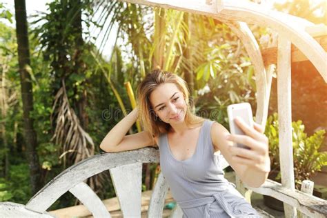 Woman Taking Selfie With Smartphone On Sunny Day Background Of