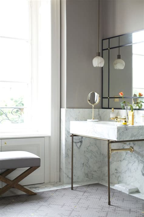 Place bathroom pendant fixtures around a vanity to free up your wall space for mirrors and cabinets. Small petal-like pendant light above a marble sink - Decoist