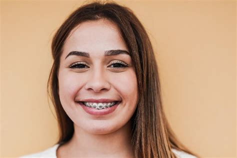 Premium Photo Beautiful Teenage Girl With Dental Braces Smiling On Camera