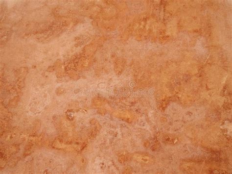 Close Up Of A Rough Textured Ocher Stone Wall Background Stock Photo