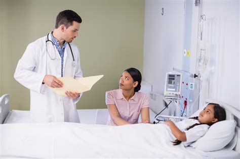 Premium Photo Doctor And Nurse Interacting With Girl Patient
