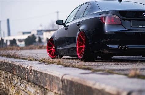 Custom Red Jr Wheels As A Focal Point On Black Bmw 5 Series —