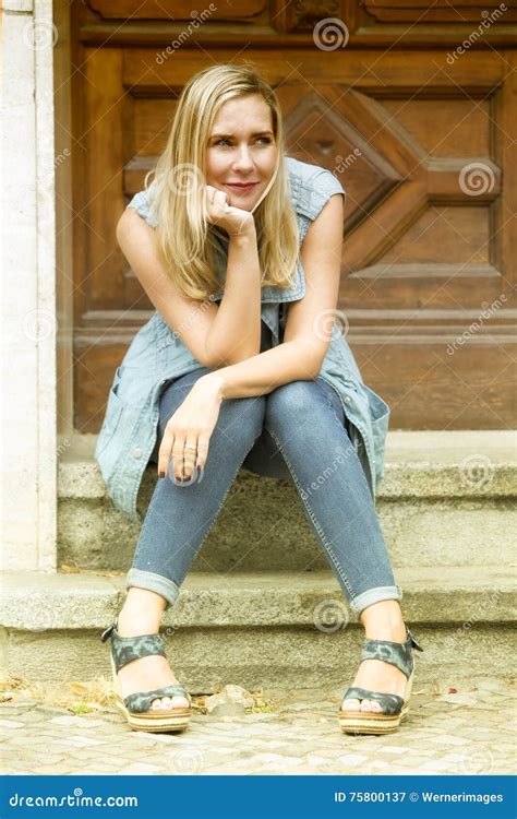 Woman Sitting In Front Of Wooden Door On Steps Stock Image Image Of
