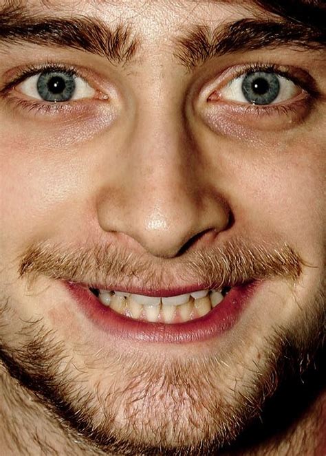 A Close Up Of A Smiling Man With Blue Eyes