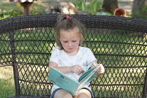 Little Girl Reading A Book Outside Free Stock Photo Public Domain