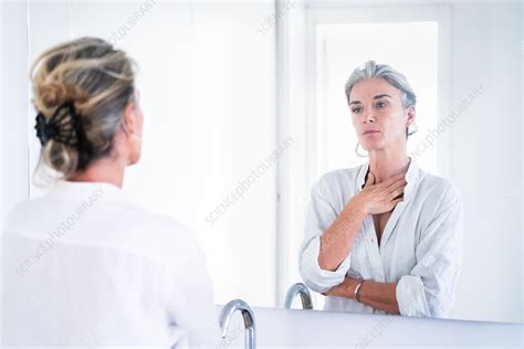 Woman Looking At Herself In A Mirror Stock Image C050 7836 Science Photo Library
