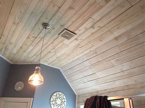 As you approach the location of ceiling lights and fans marked on the ceiling, use the jigsaw to cut holes in the tongue and groove planks to allow passage of wires through the ceiling and for ornamental. Whitewashed rough cedar in master bath on ceiling ...