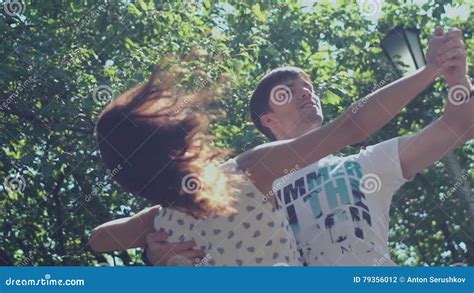 Couple Waltzes In A Summer Park On A Background Of Green Trees Stock