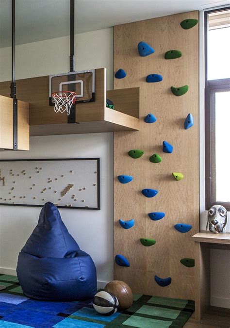 A Fun Kids Bedroom With A Loft Bed And Rock Climbing Wall